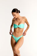 Aqua Azura twist bandeau bikini top and high cut bottoms on model, Bailee Swim