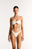 Ivory Azura twist bandeau bikini top and high cut bottoms on model, Bailee Swim